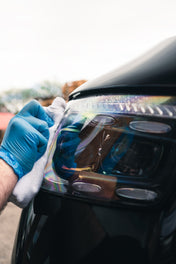 Ceramic glass cleaner being used on automotive headlights